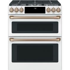 two white and gold ovens side by side with the top one showing its burners