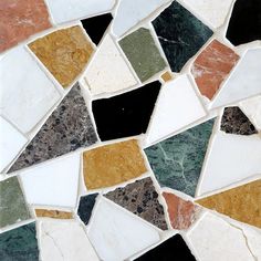 an assortment of multicolored marble tiles with different shapes, sizes and colors on them