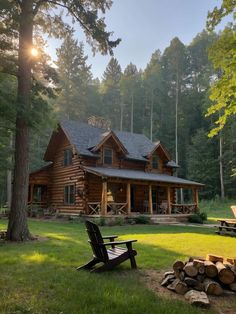 a log cabin sits in the middle of a grassy area next to a pile of firewood