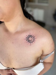 a woman with a sun and moon tattoo on her chest