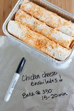 an enchilada is in a pan with a pen on the table next to it