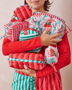 a woman is holding several pieces of fabric