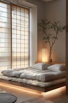 a large bed sitting in a bedroom next to a window with blinds on the windowsill