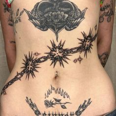 a woman's back with tattoos on her stomach and the bottom part of her body