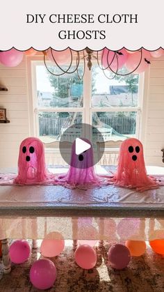 three pink ghost decorations sitting on top of a table next to a window with the words diy cheese cloth ghosts