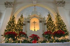 a church decorated with christmas trees and lights