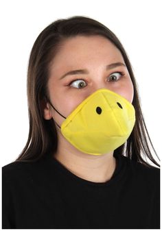 a woman wearing a yellow mask with a ducky face on it's mouth