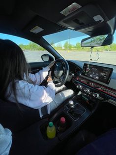 a woman driving a car on the road