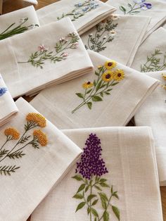 several embroidered napkins with flowers on them