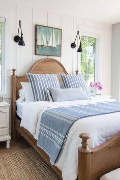 a bed with blue and white sheets in a bedroom