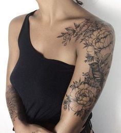 a woman with tattoos on her arm and shoulder