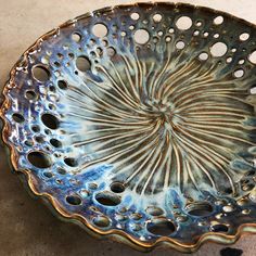 a decorative bowl with holes in the center