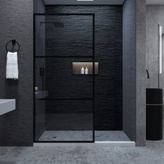 a black and white bathroom with a glass shower door