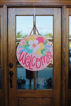 a welcome sign hangs on the front door