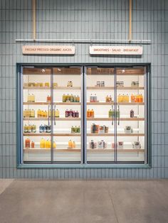 a store front with two glass doors and shelves filled with different types of products on display