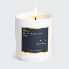 a candle that is sitting in front of a white background with the words maison franois knicklipian oud on it