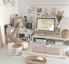 a desk with a computer, keyboard, mouse and other office supplies on top of it