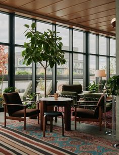 a living room filled with furniture and large windows