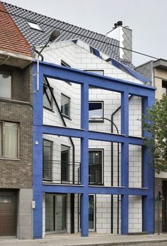 a blue and white building on the corner of a street