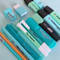 several pens are lined up next to each other with erasers on top of them