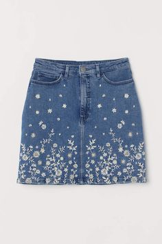 a denim skirt with embroidered flowers on the front and side, in light indigo blue