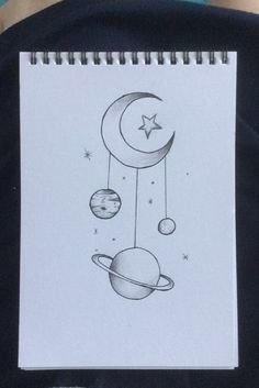 a drawing of the moon and planets is shown on a piece of paper that has been drawn