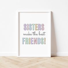 a white frame with the words sisters make the best friends on it in multicolored letters