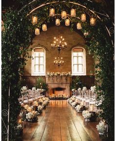 an indoor wedding venue with candles and greenery