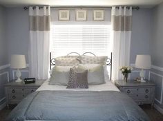 a bedroom with blue walls and white bedding