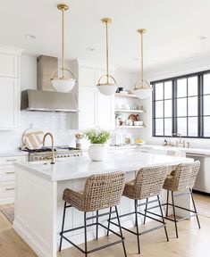 a kitchen with white counter tops and chairs