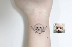 a small tattoo on the wrist of a dog