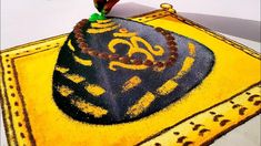 a yellow and black cake on top of a table