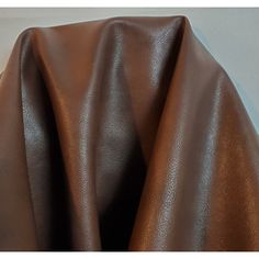 a close up view of a brown leather material that looks like it has been made out of