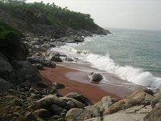 a rocky beach with waves crashing into the shore