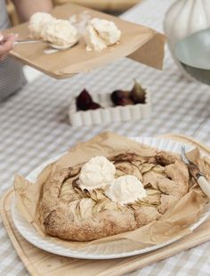 a table topped with a pie covered in whipped cream