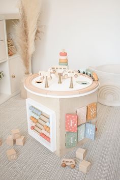 a toy house with lots of wooden blocks on the floor