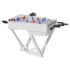 a white foosball table with red and blue pieces on it