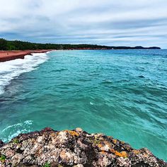 the water is very blue and green with rocks on both sides that look like corals