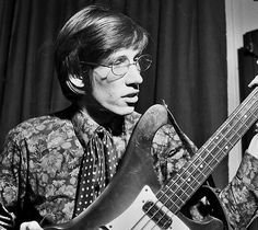 black and white photograph of man playing bass guitar