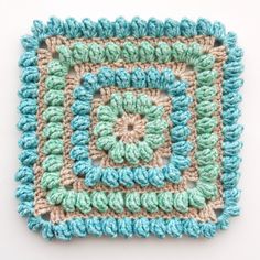 a crocheted square is shown on a white surface