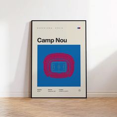 a poster with the words camp nou in red and blue on it next to a wooden floor