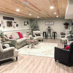 a living room with couches, chairs and a christmas tree in the corner on the wall