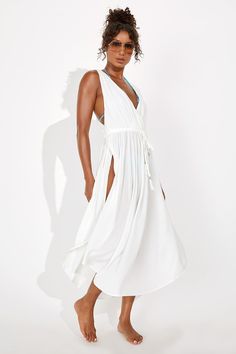 A trip to the sea isn't complete without the Lulus Santorini Sun White Drawstring Swim Cover-Up Dress! This gauzy, crinkle-woven swim cover-up is perfect for pulling on over your bikini and hitting the town with its surplice bodice and wide tank straps that flow into a racerback. Drawstring waist has tasseled ties above a maxi skirt with side slits. Fit: This garment fits true to size. Length: Ankle length. Size medium measures 49.5" from shoulder to hem. Bust: Great for any cup size. Waist: Fit Swimsuit Coverup Outfits, Cute Swim Coverups, Triangle Dress, White Cover Up, White Bathing Suit, Swim Cover Up Dress, Practice Outfits, Lulu Fashion