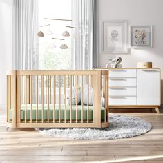 a baby's room with a crib and dresser