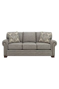 a gray couch with two pillows on it