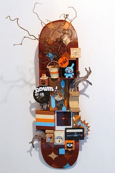 a sculpture made out of assorted items on a white wall