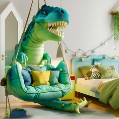 a child's bedroom decorated in green, blue and yellow with a dinosaur hanging from the ceiling