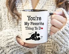 a woman holding a coffee mug with the words you're my favorite thing to do