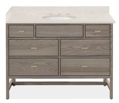 an image of a bathroom vanity with white counter top and grey wooden drawer drawers on the bottom