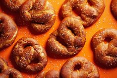 freshly baked bagels with sesame seeds on an orange surface